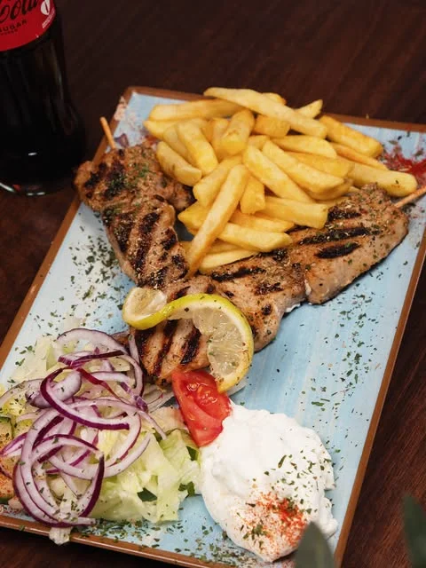 Grilled meat with fries, tzatziki and salad at Zaki’s
